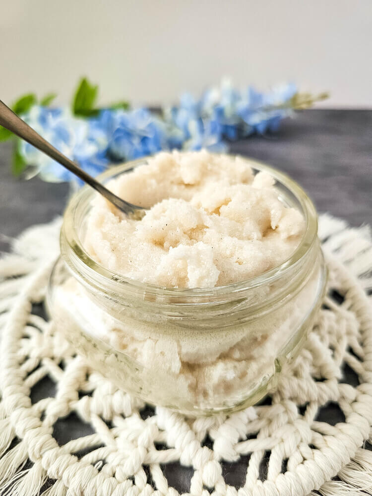 Lemon vanilla whipped sugar scrub in a glass jar with spoon.