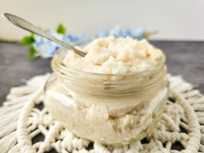 Side view of lemon vanilla whipped sugar scrub in jar.
