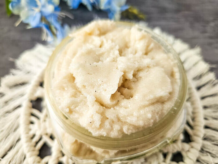 Top view of lemon vanilla whipped sugar scrub in glass jar.