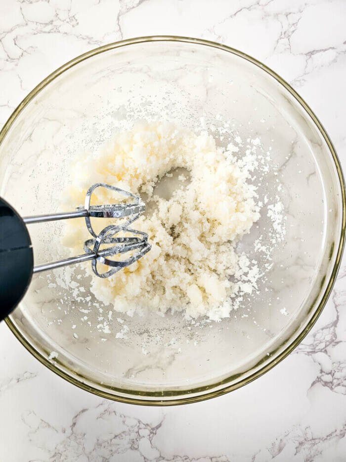 Mixing sugar scrub with hand mixer.