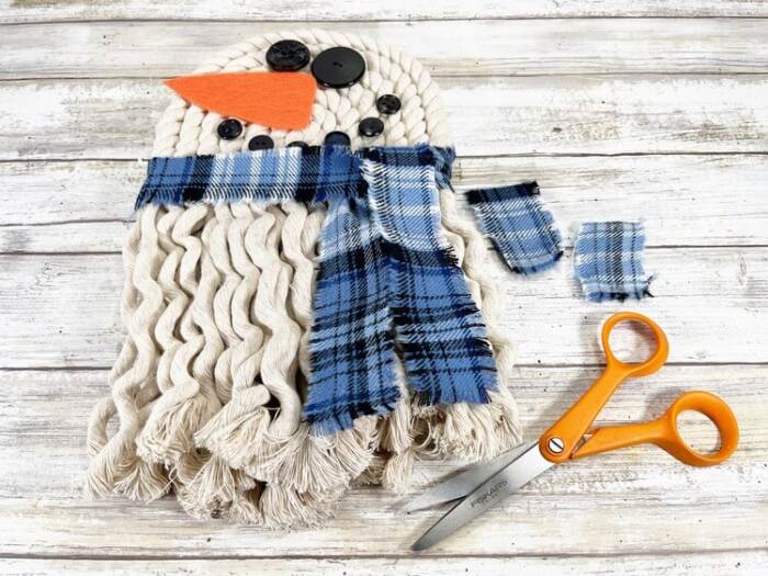 attaching plaid scarf to rope snowman wall decor