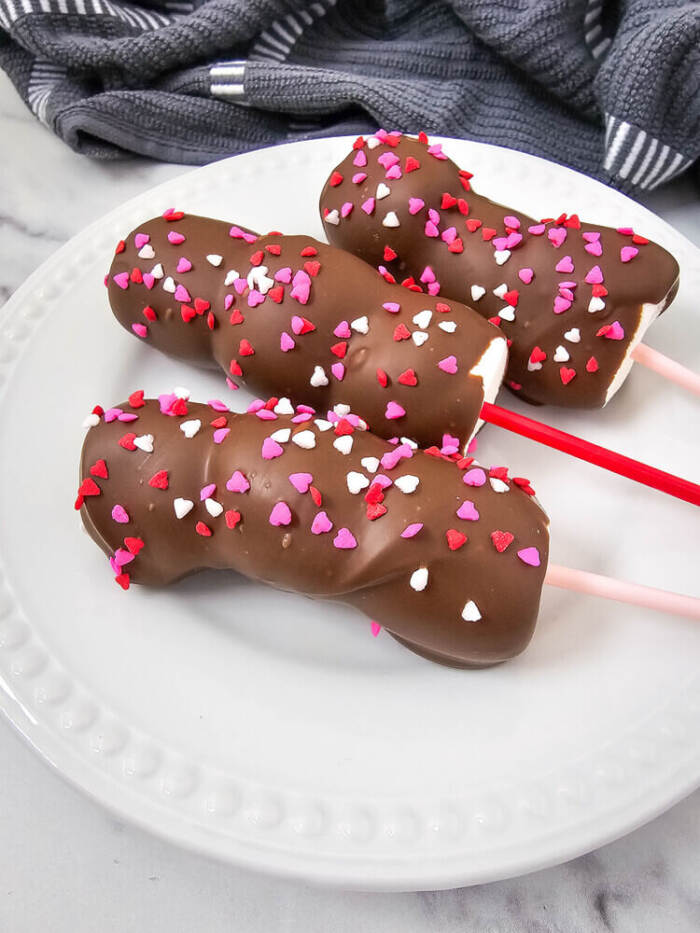Valentine’s-themed marshmallow pops with pink and red candy and sprinkles on sticks