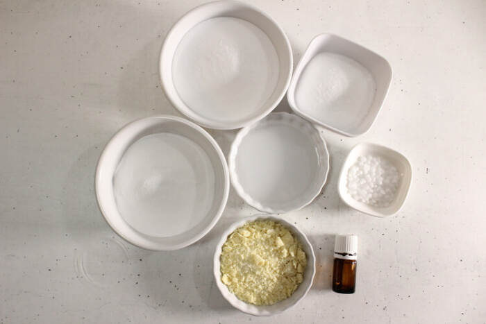 Ingredients for easy bubble bath bar DIY laid out in white bowls