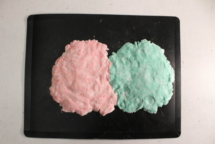 Colored bubble bath bar dough flattened on cutting board