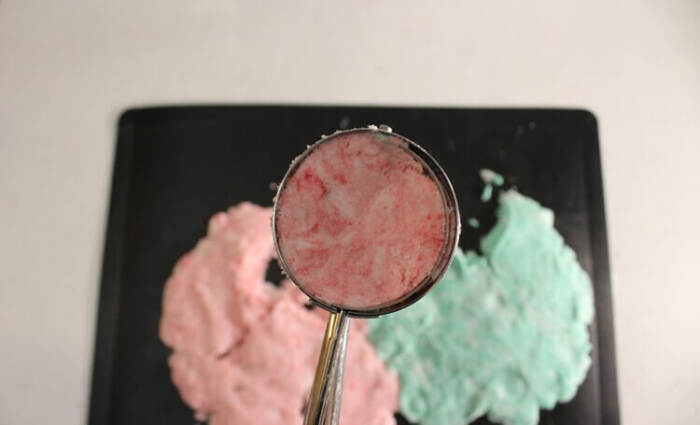 Scooping bubble bath bar dough with ice cream scoop