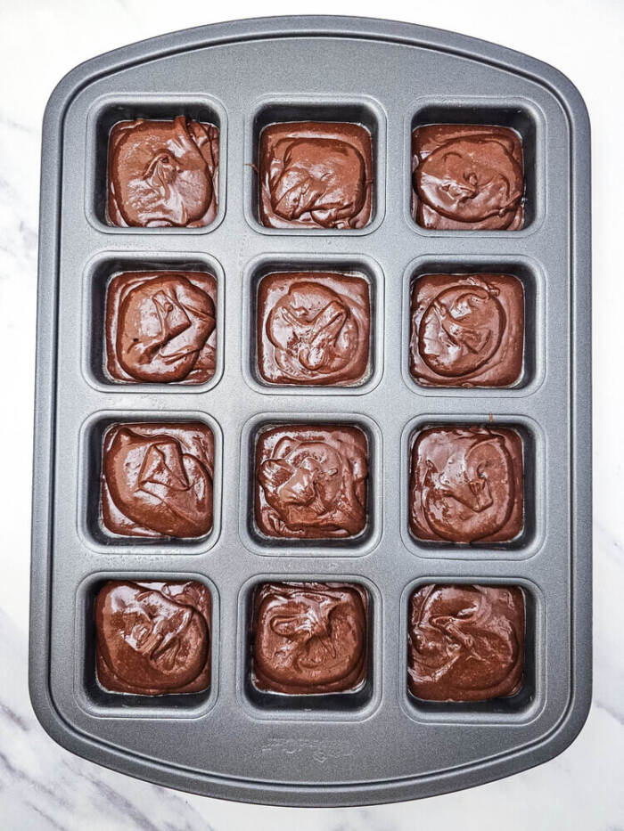 10. Brownie batter divided into brownie pan cavities