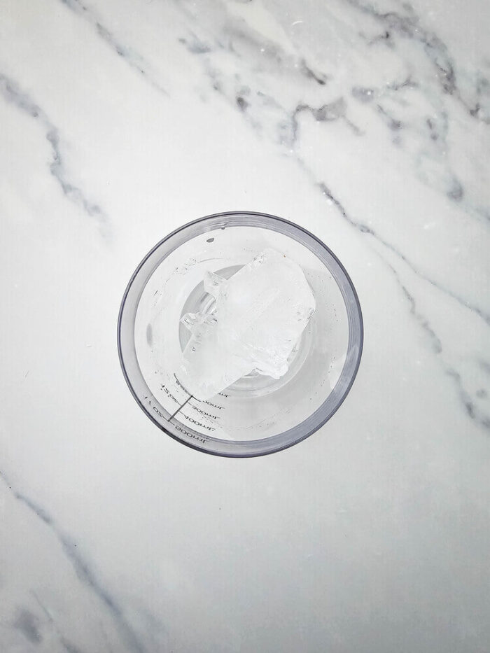 A shaker bottle with ice inside for watermelon Jolly rancher drink.