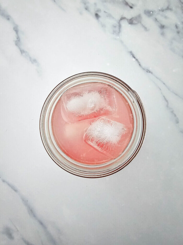 Overhead view of a glass filled with watermelon Jolly rancher drink mixture added with grenadine.