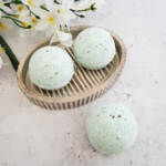 Eucalyptus bath bombs beside a flower.