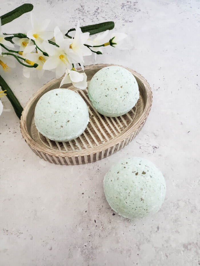 Eucalyptus bath bombs beside a flower.