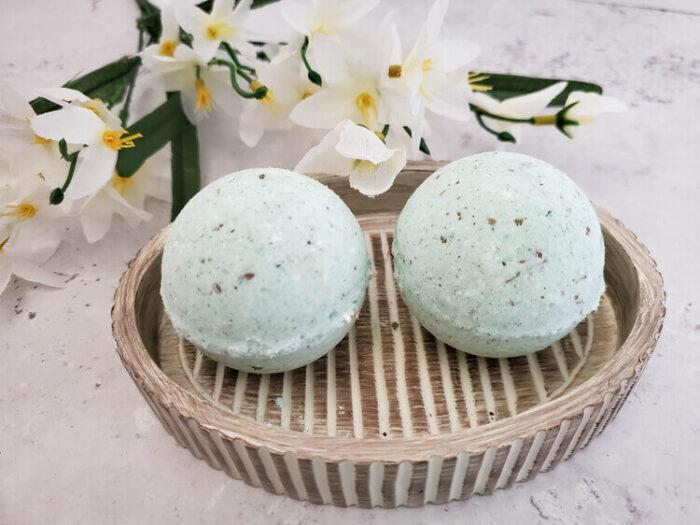 Two eucalyptus bath bombs in a small wooden tray.