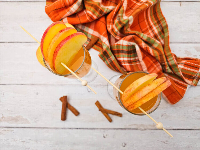 overhead view of two glasses of drink made with apple cider mimosas recipe.