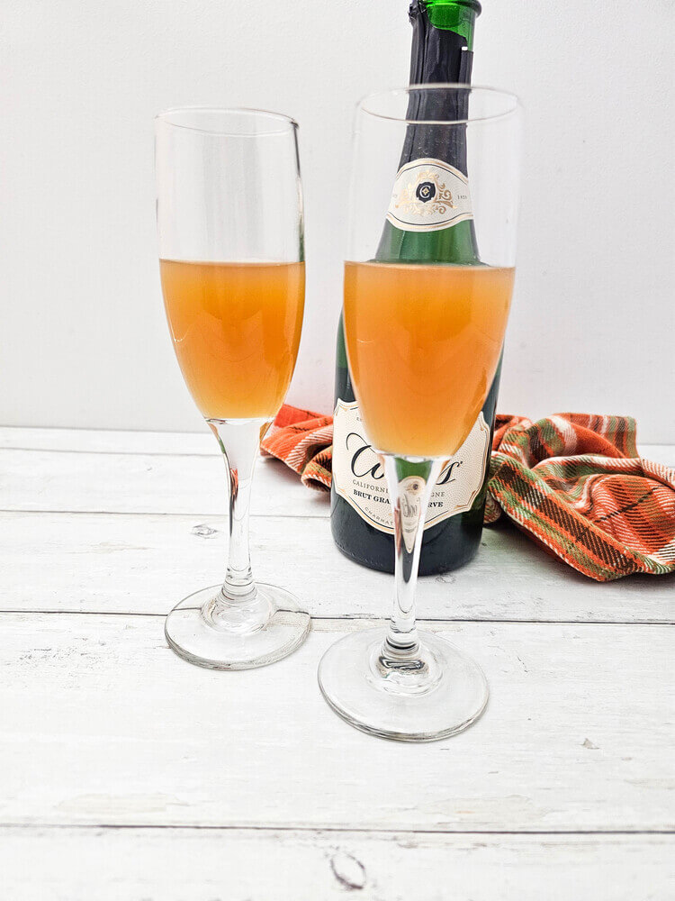 Apple cider in a champagne flute for apple cider mimosas recipe.