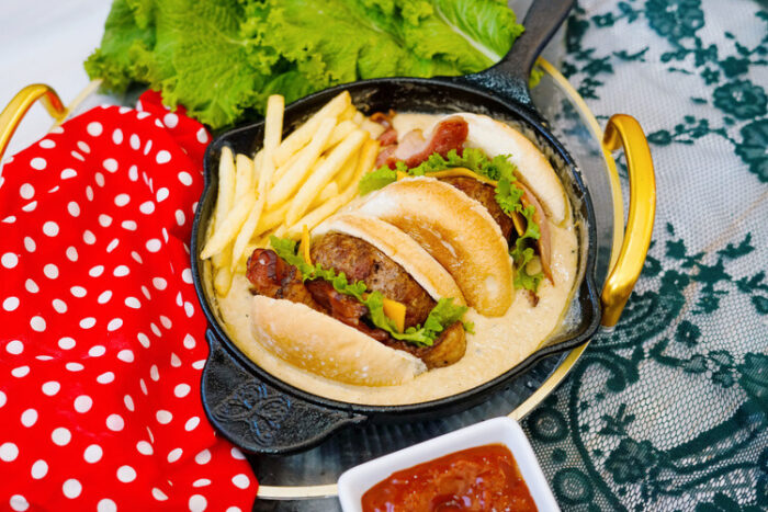 Copycat Applebee's O-M-Cheese Burger in a skillet on a table.