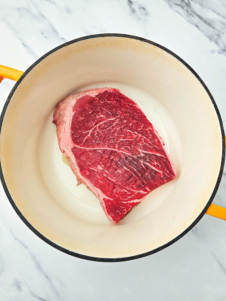 Overhead view of raw meat for dutch oven mississippi pot roast.