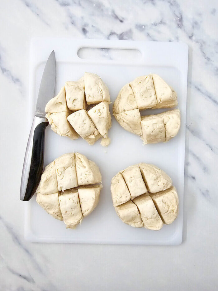 Overhead view of sliced biscuit dough for biscuit pizza casserole.