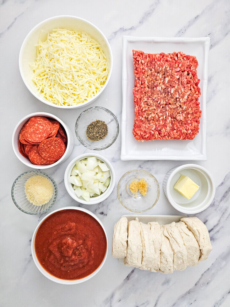 Overhead view of biscuit pizza casserole ingredients.