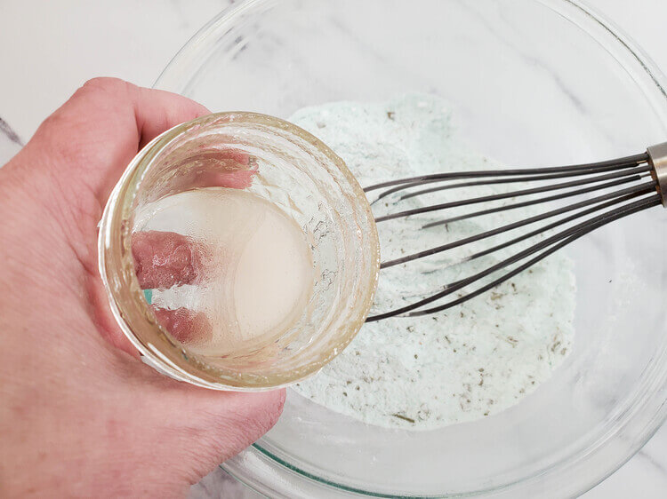 Eucalyptus bath bombs ingredients being mixed in a large bowl.