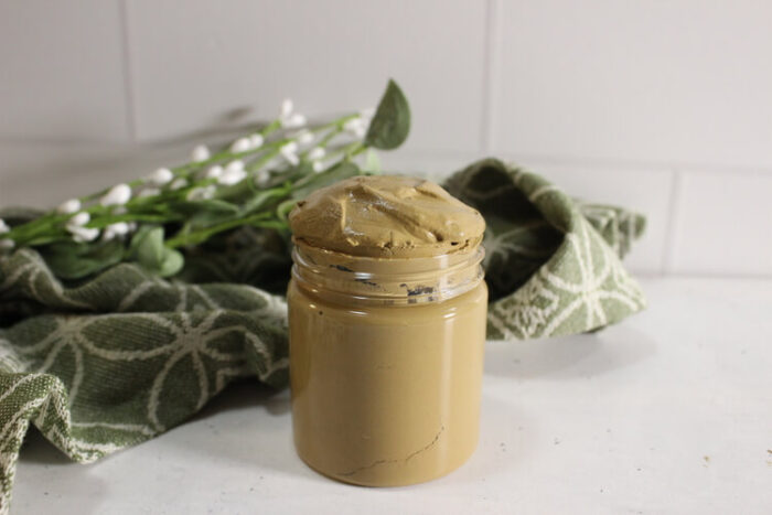 A jar of poison ivy paste diy close up look.